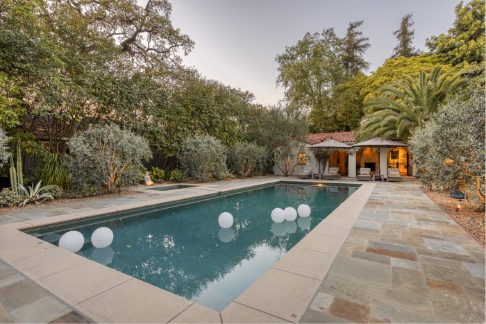 view of pool and poolhouse