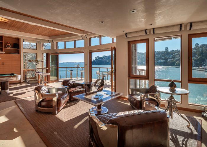 Waterfront home with leather easy chars and a pool table.