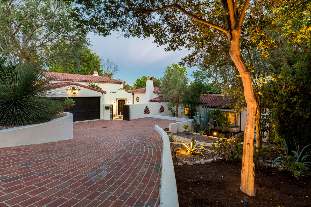 brick driveway and Spanish home