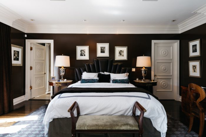 Master suite with brown paint and family photos.