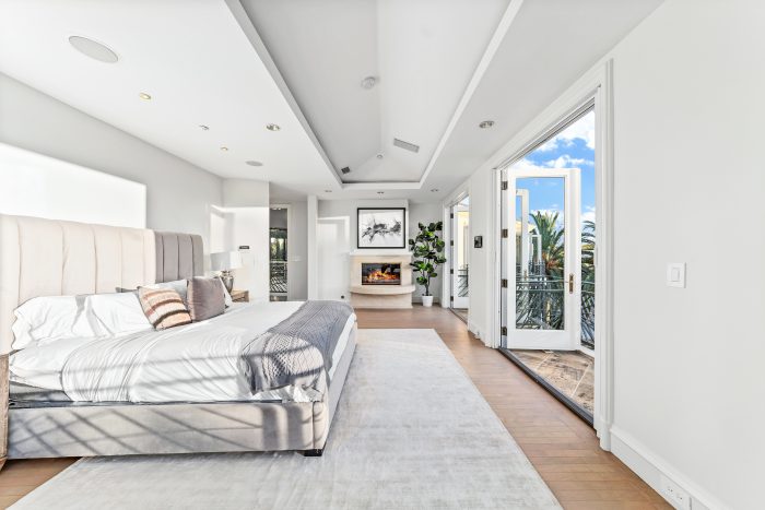 Master sweet with enormous bed, fireplace, and windows that open to the outside.