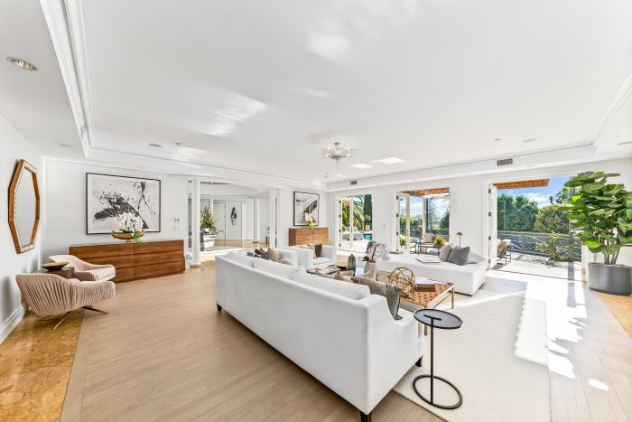 Living room with doors that open one wall to the deck.