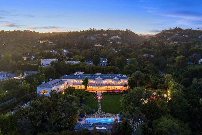 Aerial view of Los Angeles estate, illuminated wit the sunset on the horizon.