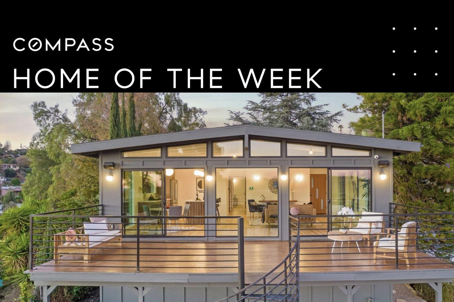 Grey House deck view with lights inside