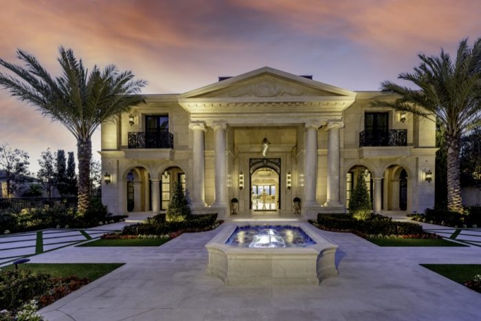 Front view of mansion at sunset.