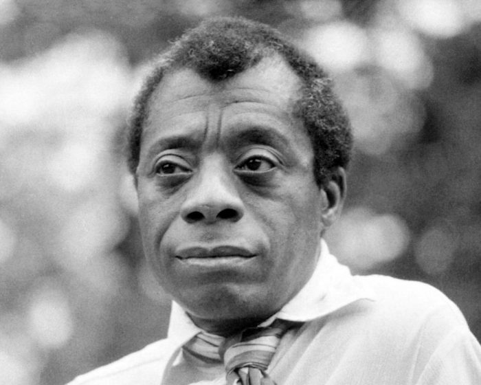 View of James Baldwin, shown wearing a tie 