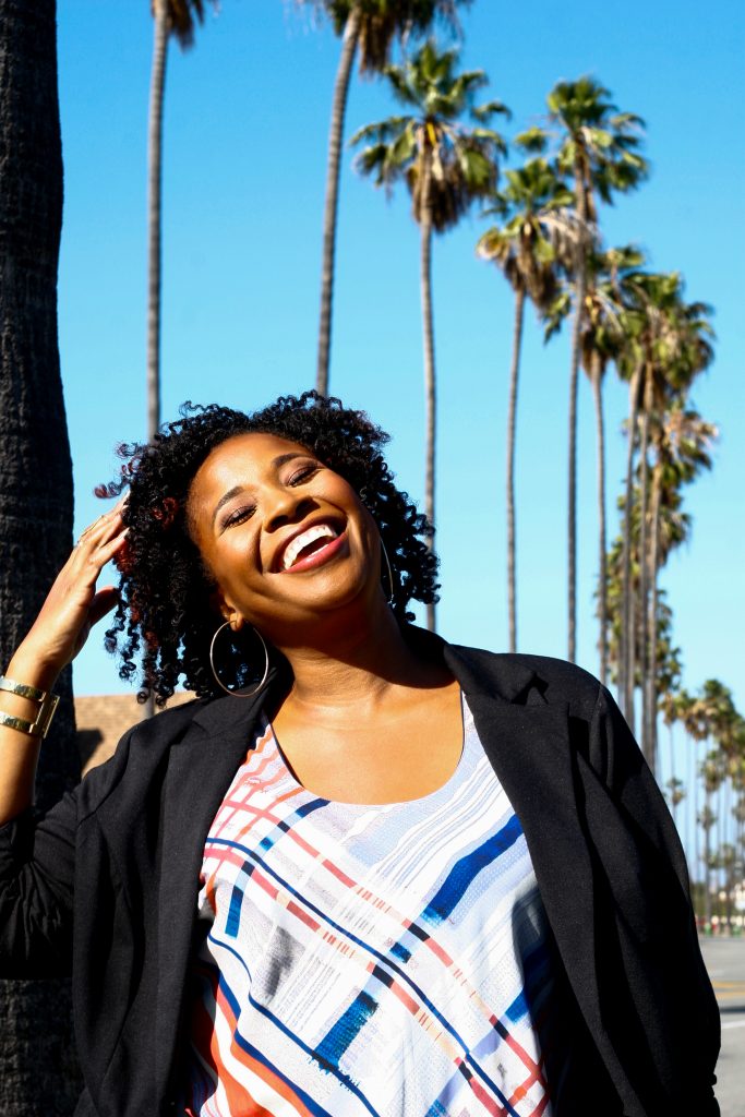 Woman with palm trees in background. 
