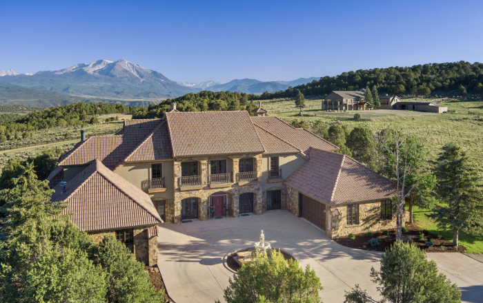County road property with mountains in the background.