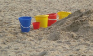 Photo of plastic buckets on a beach