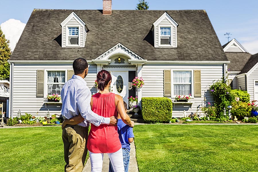 family in front of home