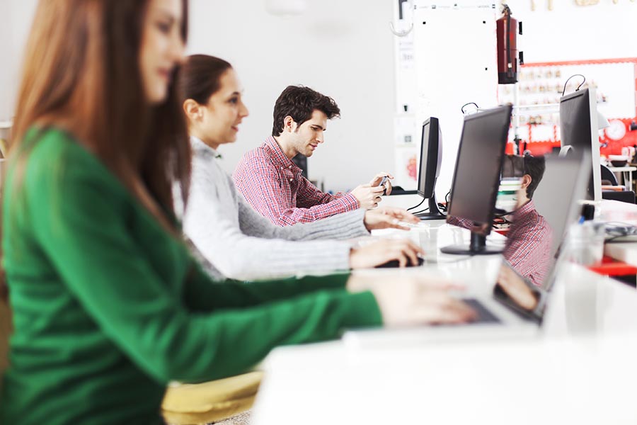 Working on new apps. Young business group.