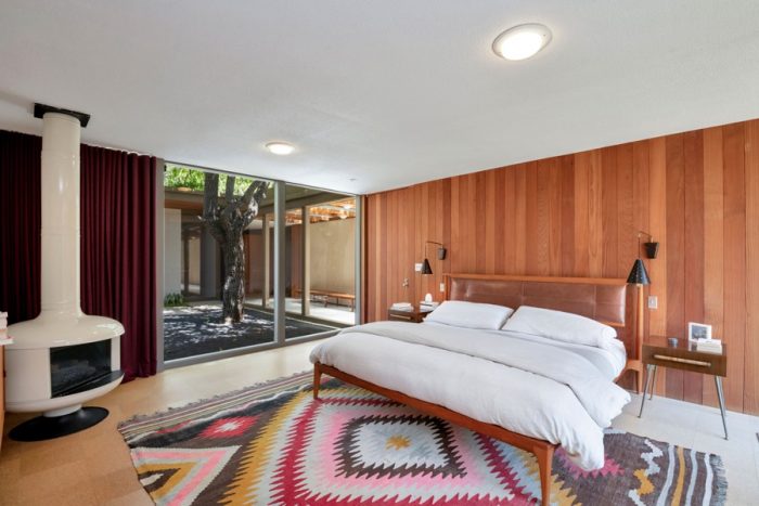 Compass master suite with Mexican weaving and wood stove.