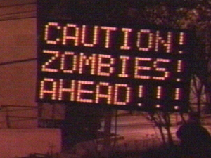 Highway sign warning of zombies ahead